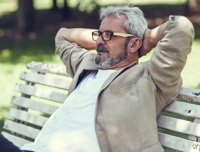 Mature man relaxing on a park bench